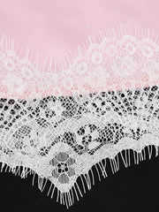Pink satin camisole with white lace trim detail and asymmetrical hem.