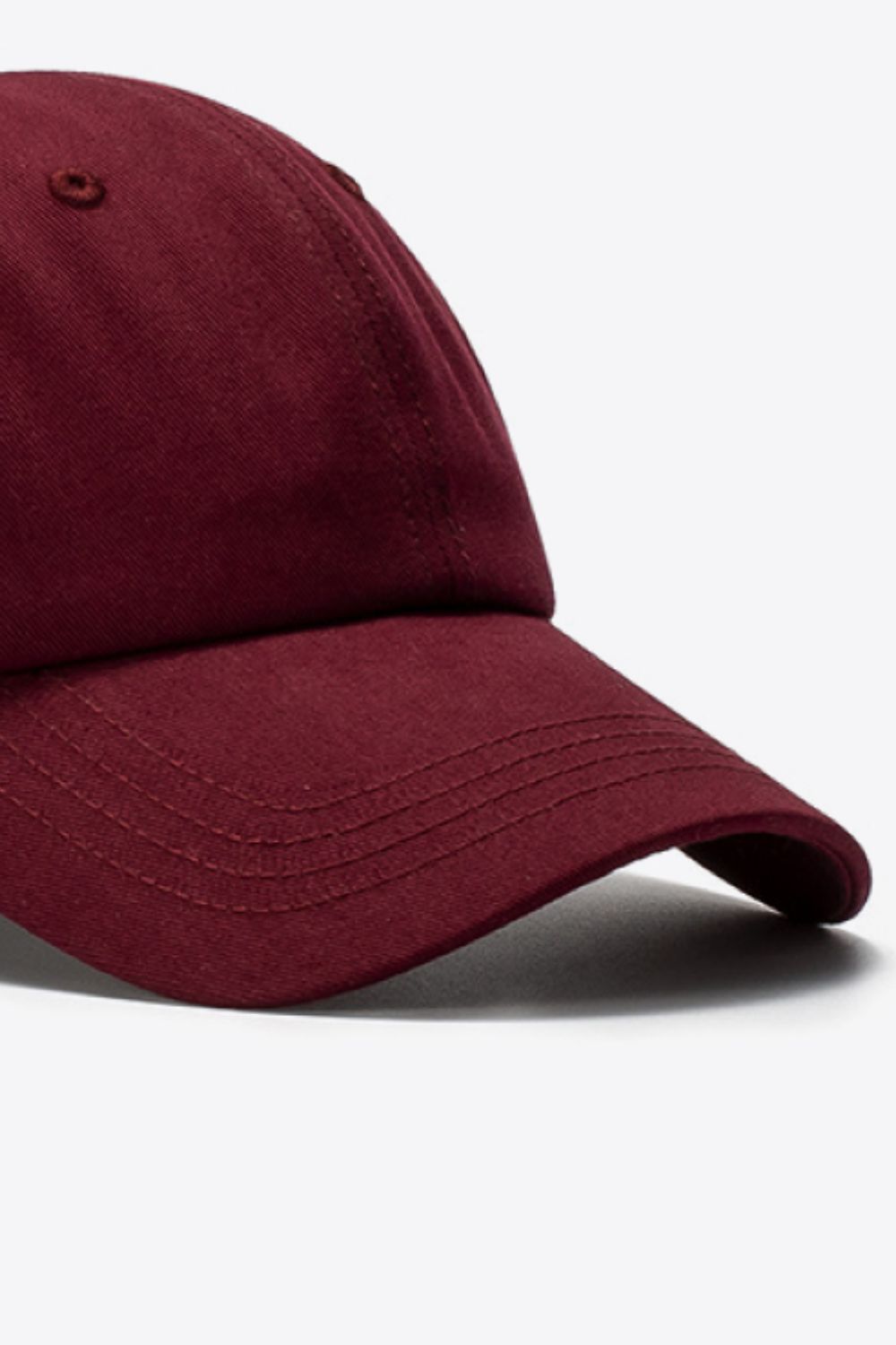Wine cotton baseball cap with stitched details on the brim.