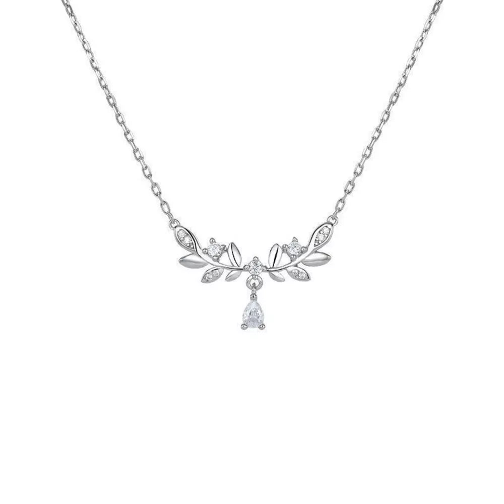 Silver zircon flower pendant necklace with delicate leaf design and pear-shaped drop.