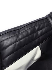 Black and white color block sport jacket with quilted shoulder detail.