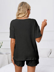 Black ribbed knit pajama set with short sleeves and shorts.