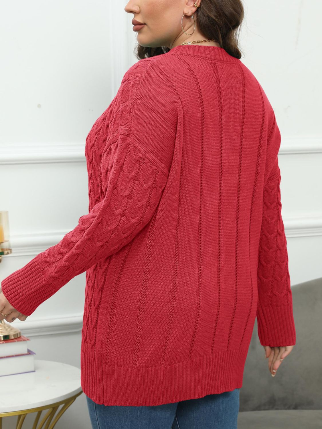 Deep Red cable knit sweater with diamond stitch detail on sleeves and ribbed back.