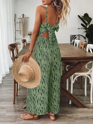 Matcha green wide-leg jumpsuit with back bow detail and abstract print.