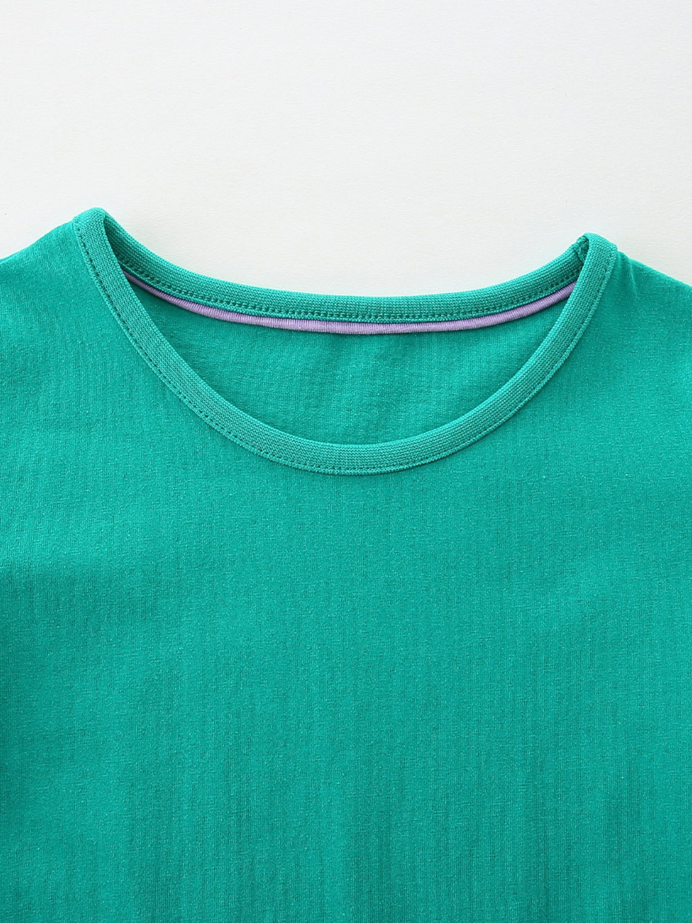 Green cotton toddler dress with embroidered dog design and striped neckline detail.