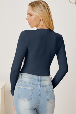Dark blue ribbed long sleeve bodysuit with plunge neckline, styled with jeans