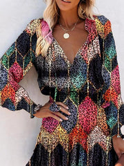Abstract speckled tiered dress with ruffles and V-neck in multicolor leopard print.