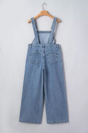 Retro pleated wide-leg denim jumpsuit with buttoned straps and back pockets.