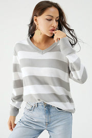 Gray and white striped V-neck relaxed knit sweater with ribbed cuffs and hem