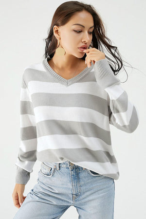 Gray and white striped V-neck relaxed knit sweater with ribbed cuffs and hem