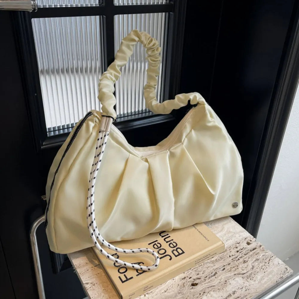 Ivory ruched handle crescent shoulder bag with rope strap detail.