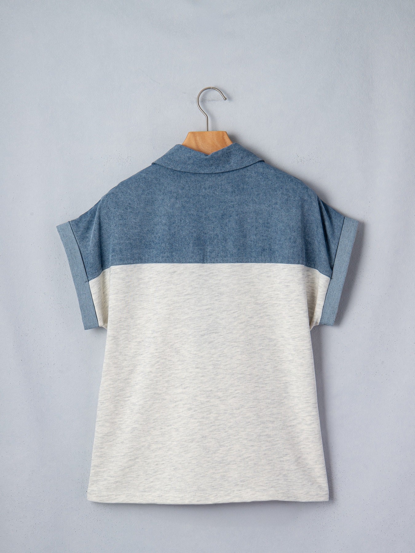 Two-tone denim polo shirt with rolled sleeves and a classic collar.