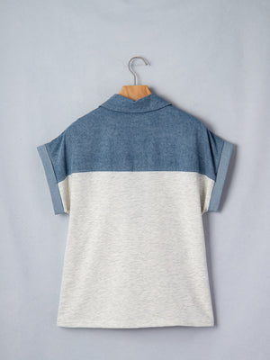 Two-tone denim polo shirt with rolled sleeves and a classic collar.