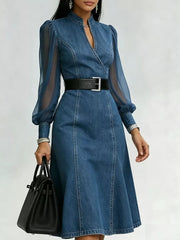 Denim midi dress with sheer puff sleeves, V-neck, and a black belt.