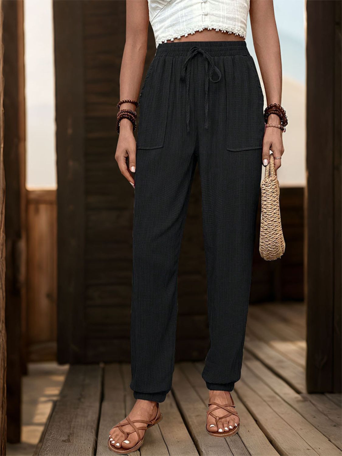 Black textured drawstring waist relaxed trousers with pockets