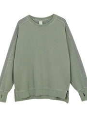 Sage oversized sweatshirt with raw-edge seams and thumbholes.