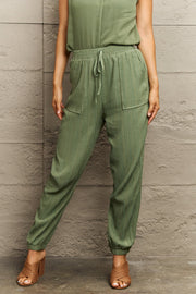 Matcha green textured gauze drawstring jogger trousers with elastic cuffs and pockets.