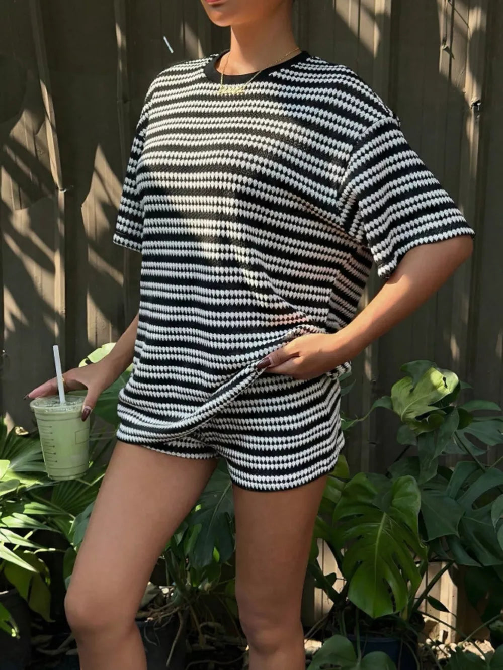 Black stripes relaxed fit two-piece set with short sleeves and shorts.