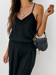 Black pleated palazzo pants and cami set with gold hardware bag.