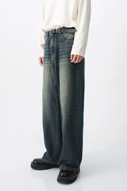 Faded wash wide-leg denim jeans in medium color, featuring a relaxed fit and distressed details.