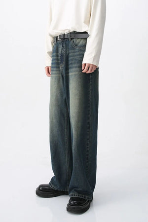 Faded wash wide-leg denim jeans in medium color, featuring a relaxed fit and distressed details.