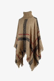 Camel plaid turtleneck cape with fringe detail and textured acrylic knit.