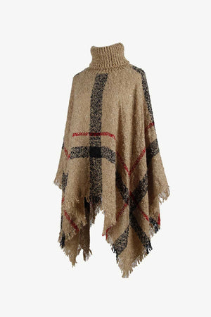 Camel plaid turtleneck cape with fringe detail and textured acrylic knit.