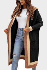 Color-blocked hooded knit maxi cardigan in black with tan and brown trim, featuring pockets.
