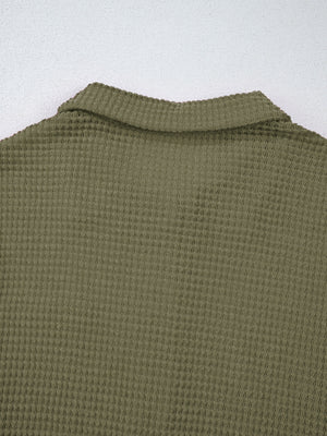Moss waffle-knit collared shirt with button detail and textured fabric.