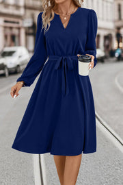 Navy midi dress with V-neck, poet sleeves, and tie waist