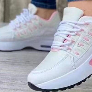 White and pink lace-up chunky platform sneakers with a textured side detail.