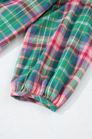 Voluminous plaid blouse with gathered sleeves and elastic cuff detail.