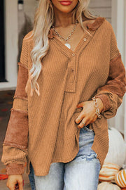 Caramel waffle knit henley top with contrast stitch detail on sleeves and collar.