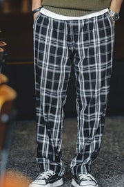 Relaxed fit black plaid men's sweatpants with a drawstring waist.