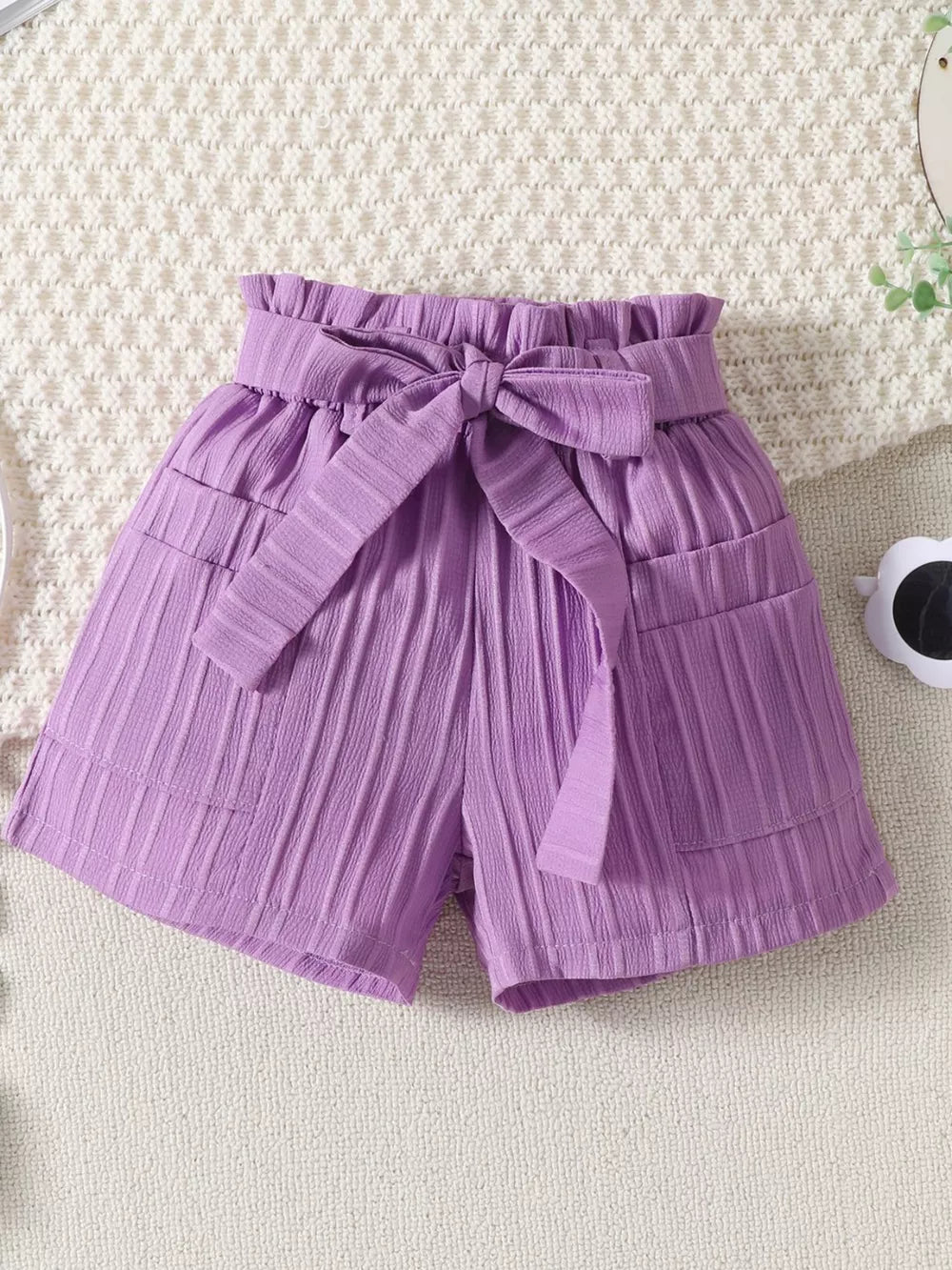 Violet ruffled ribbed toddler shorts with paperbag waist and bow tie.