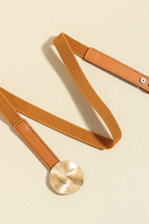Caramel elastic belt with faux leather ends and a gold disc detail.