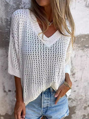 White open-knit V-neck sweater with relaxed fit and short sleeves, styled with denim shorts.