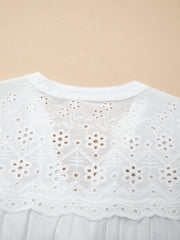 White cotton sheer shirt with floral eyelet embroidery and a button-down collar.