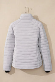Quilted stand collar puffer jacket in pastel blue with horizontal stitching detail.