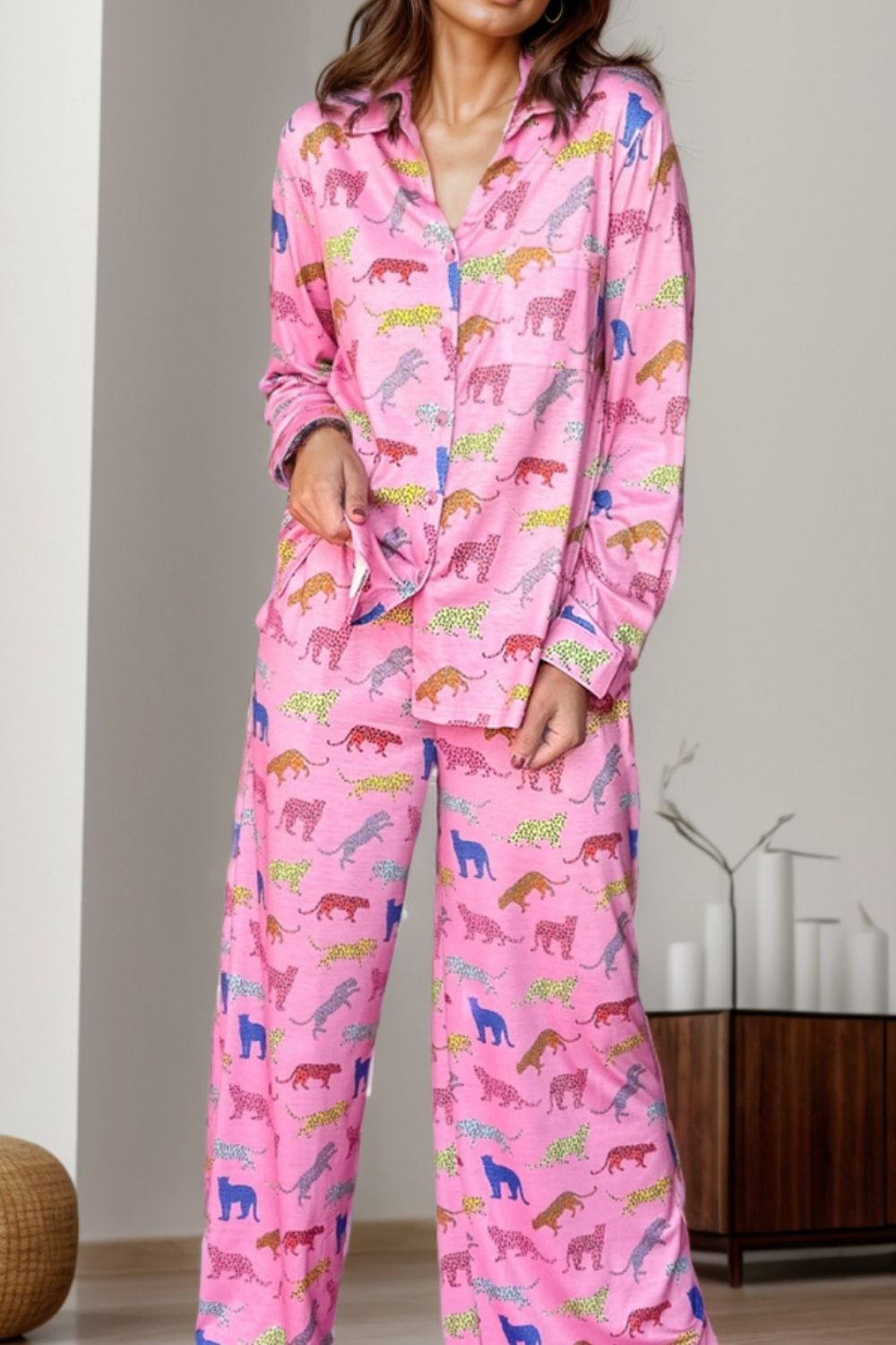 Pink leopard print pajama set with button-down top and wide-leg pants.