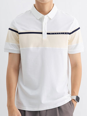 Men's white cotton polo with sherbet and navy color block details and short sleeves.