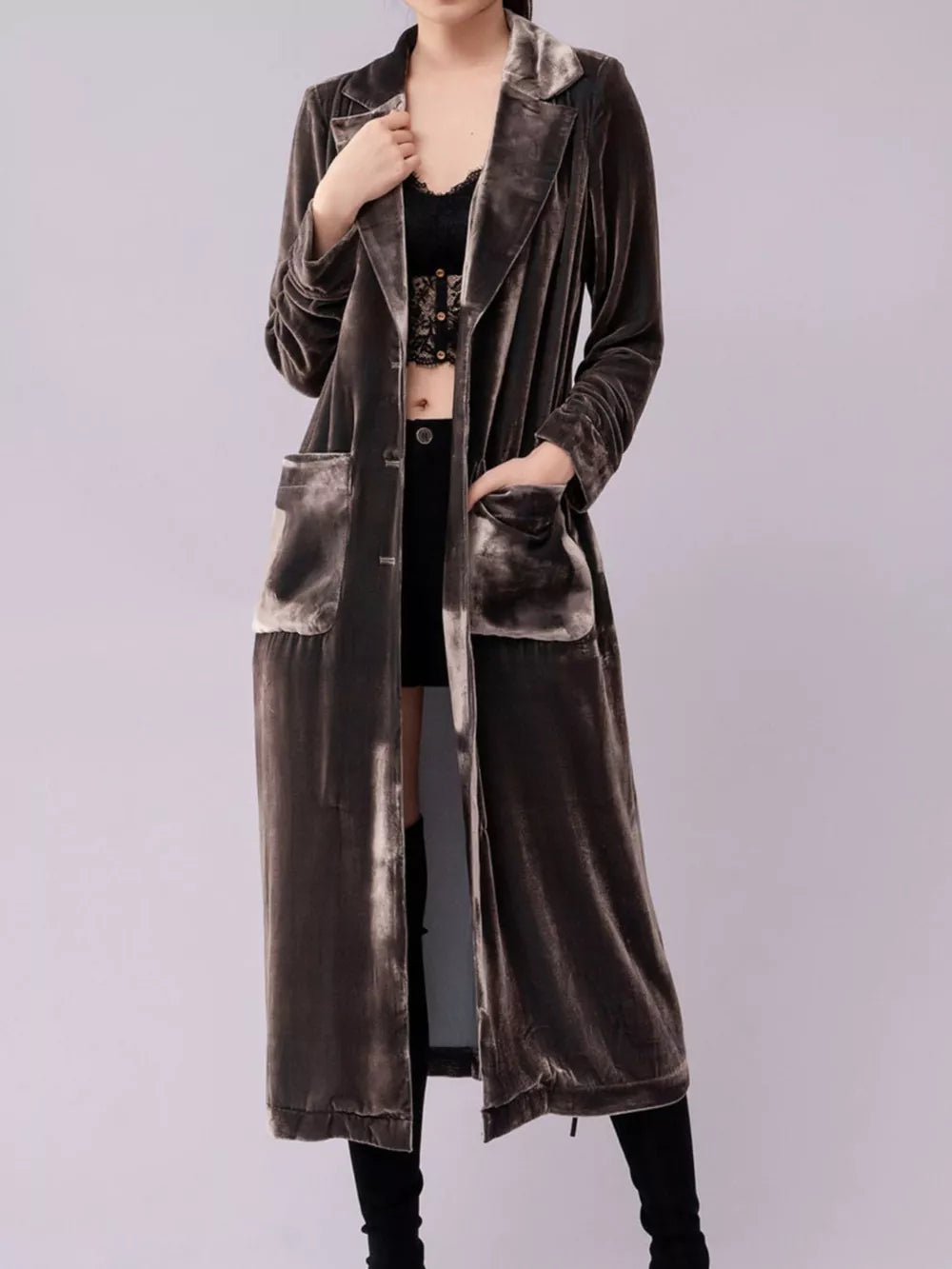 Longline velvet trench coat in a muted taupe color with draped lapels and patch pockets.