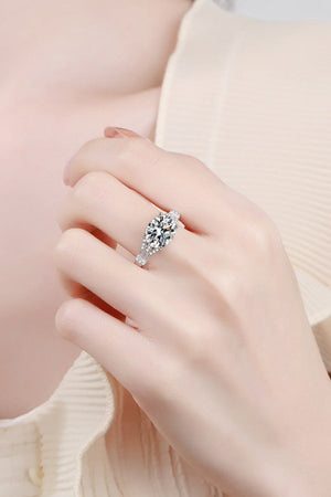 Silver pavé-set moissanite solitaire ring with a split band.