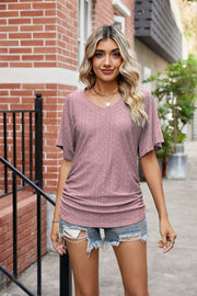 Pink perforated dolman sleeve blouse with V-neck and ruching detail
