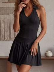 Black halter-neck pleated active dress with a collar detail.