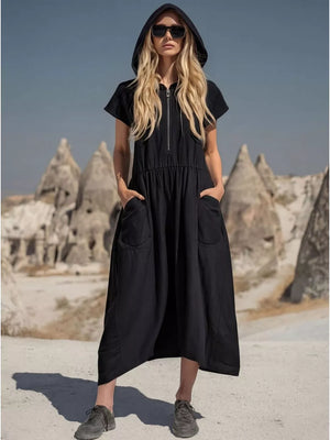 Black hooded midi dress with short sleeves, zip neckline, elastic waist, and functional pockets.