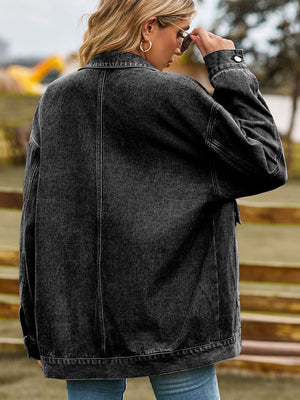Oversized dark gray denim trucker jacket with collared neck and button cuffs.