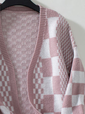 Dusty pink and white checkerboard knit open-front cardigan with textured knit details.