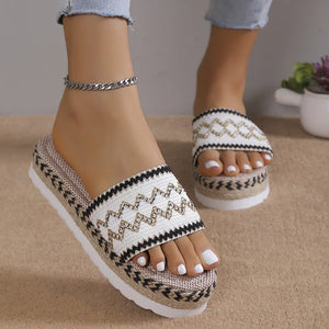 Embroidered espadrille platform slides with white and black zigzag pattern.