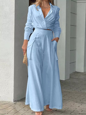 Light blue polyester two-piece set with pocketed wide-leg pants and a draped long-sleeve shirt.