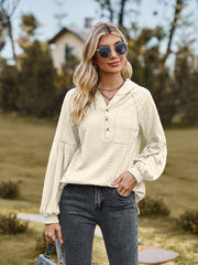 Cream textured knit henley with balloon sleeves and button detail.